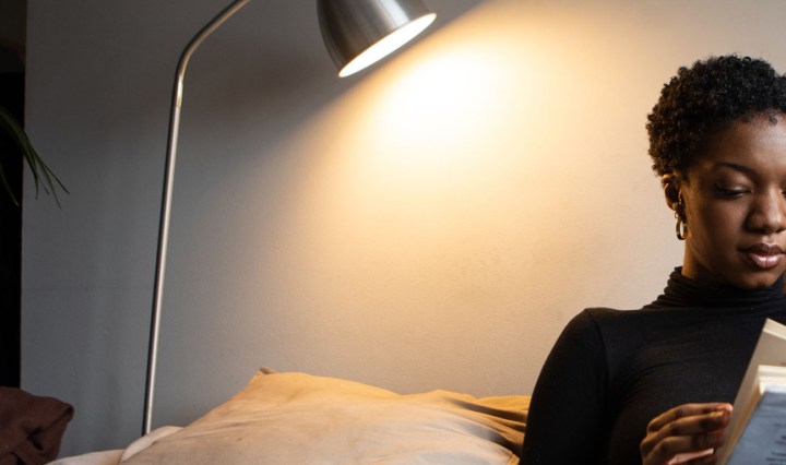 Woman reading a book from her comfortable sofa