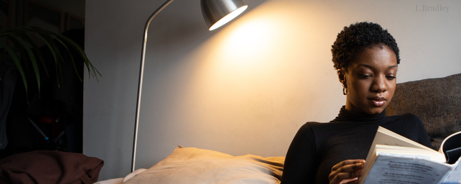 Woman reading a book from her comfortable sofa